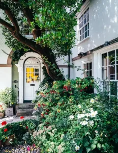 Façade d'une maison familiale avec un jardin verdoyant et apaisé, suite à un rééquilibrage de géobiologie à Champtoceaux.